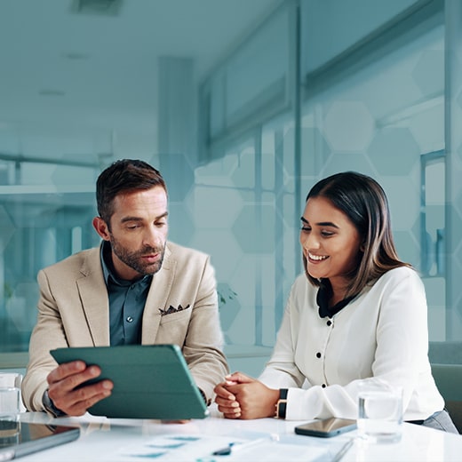 Business professionals reviewing financial data on a tablet at Afinida Accounting, specializing in expert fractional CFO services for strategic growth