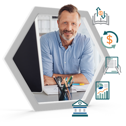Smiling man at a desk with financial documents and a computer, highlighting small business accounting, CFO, and payroll support.